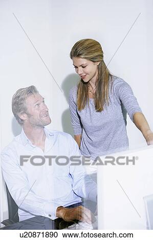 Man and woman in office on computer. View Large Photo Image Stock Image - Man and woman in office on computer.. Fotosearch