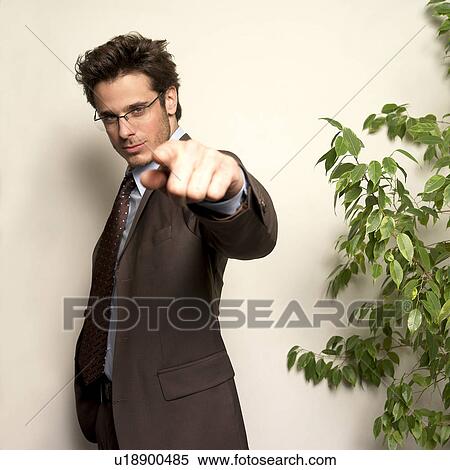 Stock Photography - Man in office looking at camera. Fotosearch