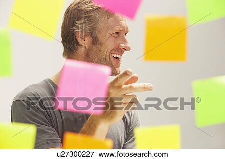 Man seen through window with colored PostIt Notes. View Large Photo Image Stock Photo - Man seen through window with colored PostIt Notes.. Fotosearch