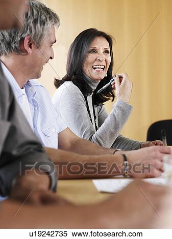 Senior businesswoman in meeting with colleagues, smiling View Large Photo Image Stock Photography - Senior businesswoman in meeting with colleagues, smiling. Fotosearch