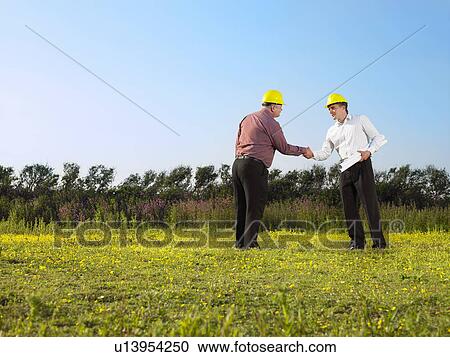 Stock Image - Surveyors on a field.. Fotosearch