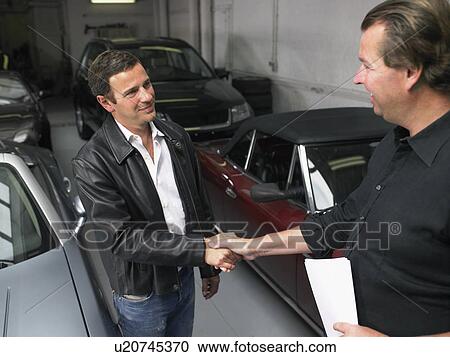Two men shaking hands in front of sports car. View Large Photo Image Stock Image - Two men shaking hands in front of sports car.. Fotosearch