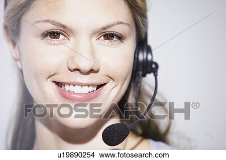 Woman with telephone headset smiling. View Large Photo Image Picture - Woman with telephone headset smiling.. Fotosearch