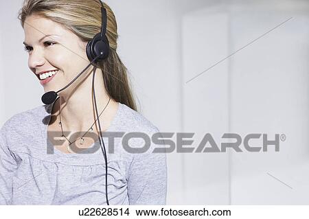Woman with telephone headset smiling. View Large Photo Image Picture - Woman with telephone headset smiling.. Fotosearch
