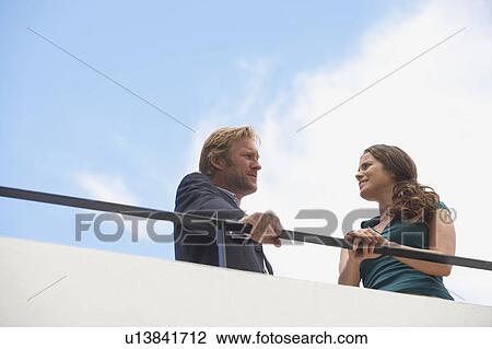 Young businessman and business woman on balcony. View Large Photo Image Stock Image - Young businessman and business woman on balcony.. Fotosearch