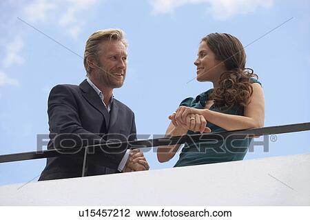 Young businessman and business woman on balcony. View Large Photo Image Stock Image - Young businessman and business woman on balcony.. Fotosearch