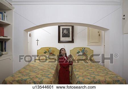 Girl (9-11) in bedroom praying View Large Photo Image Stock Image - Girl (9-11) in bedroom praying. Fotosearch