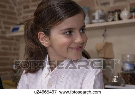 Girl (9-11) looking away, smiling View Large Photo Image Stock Photo - Girl (9-11) looking away, smiling. Fotosearch