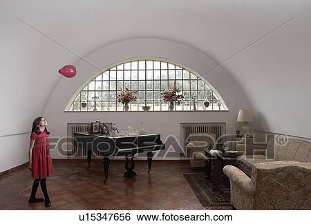 Girl (9-11) playing with red balloon in room View Large Photo Image Stock Photograph - Girl (9-11) playing with red balloon in room. Fotosearch
