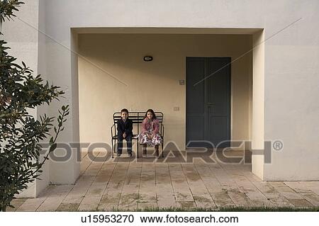 Girl and boy (6-8) sitting on bench outdoors View Large Photo Image Stock Image - Girl and boy (6-8) sitting on bench outdoors. Fotosearch