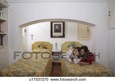 Girls (6-11) in bedroom wearing headphones View Large Photo Image Stock Image - Girls (6-11) in bedroom wearing headphones. Fotosearch