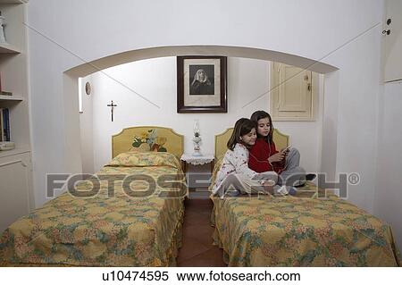 Girls (6-11) in bedroom wearing headphones View Large Photo Image Stock Photography - Girls (6-11) in bedroom wearing headphones. Fotosearch