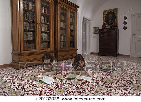 Girls (6-11) lying on floor reading books View Large Photo Image Stock Photography - Girls (6-11) lying on floor reading books. Fotosearch