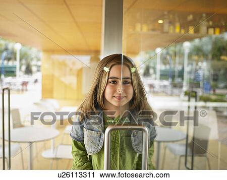 Young girl half in half out of doorway. View Large Photo Image Stock Image - Young girl half in half out of doorway.. Fotosearch