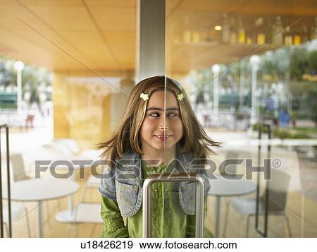 Young girl half in half out of doorway. View Large Photo Image Stock Photo - Young girl half in half out of doorway.. Fotosearch