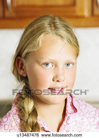 Young girl in kitchen looking at camera. View Large Photo Image Stock Photo - Young girl in kitchen looking at camera.. Fotosearch