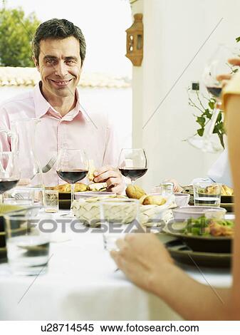 Mature man having lunch on terrace, smiling, portrait View Large Photo Image Stock Photography - Mature man having lunch on terrace, smiling, portrait. Fotosearch
