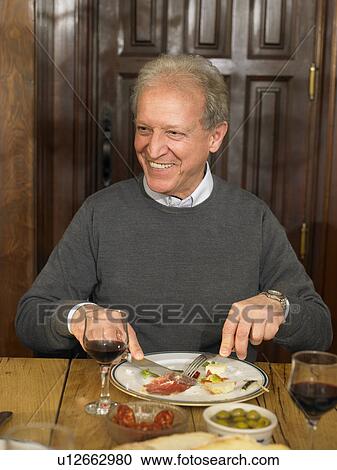 Senior man eating lunch, smiling View Large Photo Image Stock Image - Senior man eating lunch, smiling. Fotosearch