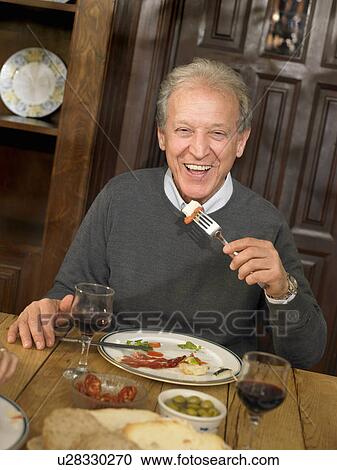 Senior man eating lunch, smiling, portrait View Large Photo Image Stock Image - Senior man eating lunch, smiling, portrait. Fotosearch