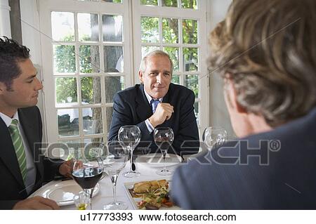 Three businessmen having lunch View Large Photo Image Stock Image - Three businessmen having lunch. Fotosearch