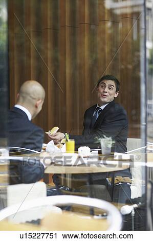 Two businessmen in a restaurant View Large Photo Image Stock Image - Two businessmen in a restaurant. Fotosearch