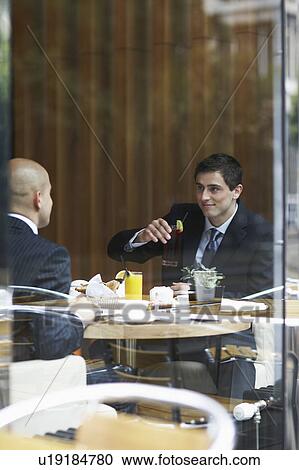 Two businessmen in a restaurant View Large Photo Image Stock Image - Two businessmen in a restaurant. Fotosearch
