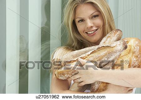 Young female holding fresh bread. View Large Photo Image Stock Image - Young female holding fresh bread.. Fotosearch