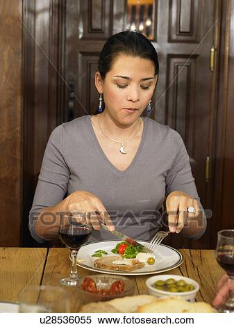 Stock Photography - Young woman eating lunch. Fotosearch