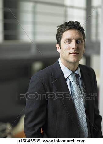 Businessman in an office View Large Photo Image Stock Photo - Businessman in an office. Fotosearch