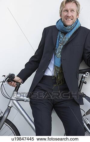 Businessman wearing extravagant scarf with bicycle. View Large Photo Image Stock Photography - Businessman wearing extravagant scarf with bicycle.. Fotosearch