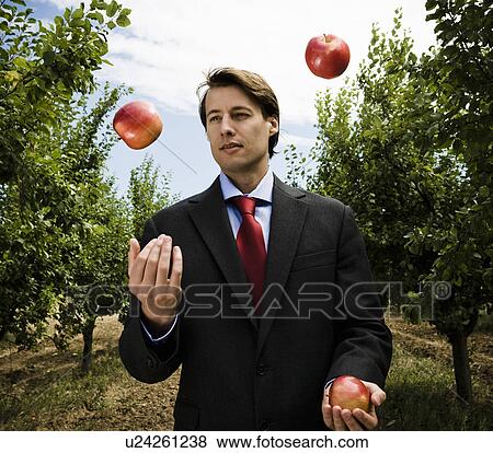 Man Juggling apples in orchard. View Large Photo Image Stock Photo - Man Juggling apples in orchard.. Fotosearch