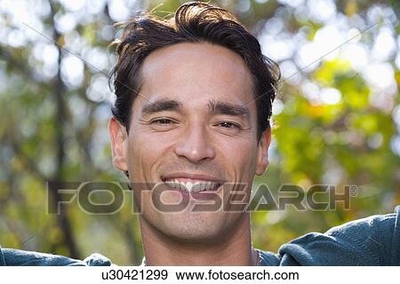 Man smiling looking at camera outdoors. View Large Photo Image Stock Photo - Man smiling looking at camera outdoors.. Fotosearch
