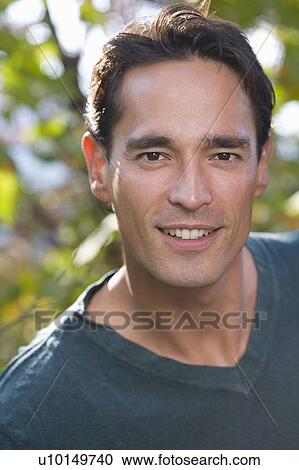 Man smiling outdoors looking at camera. View Large Photo Image Stock Image - Man smiling outdoors looking at camera.. Fotosearch