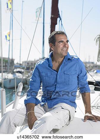 Mature man wearing relaxing on yacht, smiling View Large Photo Image Stock Image - Mature man wearing relaxing on yacht, smiling. Fotosearch