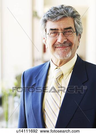 Senior businessman wearing spectacles, smiling, portrait View Large Photo Image Stock Image - Senior businessman wearing spectacles, smiling, portrait. Fotosearch