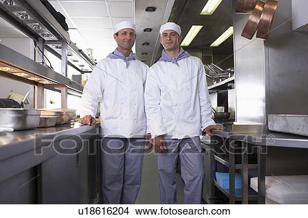 Two chefs posing in their kitchen View Large Photo Image Picture - Two chefs posing in their kitchen. Fotosearch
