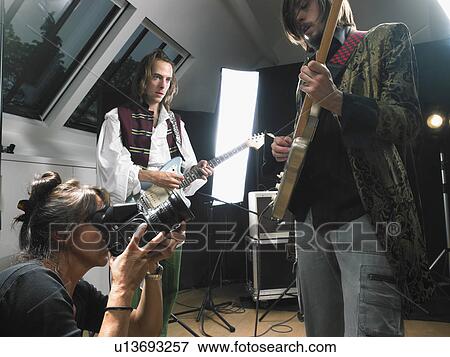 Female photographer shooting two electric guitar players in studio. View Large Photo Image Stock Photo - Female photographer shooting two electric guitar players in studio.. Fotosearch