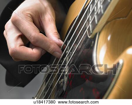 One electric guitar player close up on hand. View Large Photo Image Stock Image - One electric guitar player close up on hand.. Fotosearch