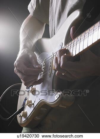 One electric guitar player close up on hands backlit. View Large Photo Image Stock Image - One electric guitar player close up on hands backlit.. Fotosearch