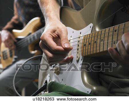 Stock Image - Two electric guitar players close up on hands.. Fotosearch