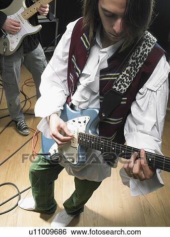 Stock Photograph - Two electric guitar players in studio.. Fotosearch