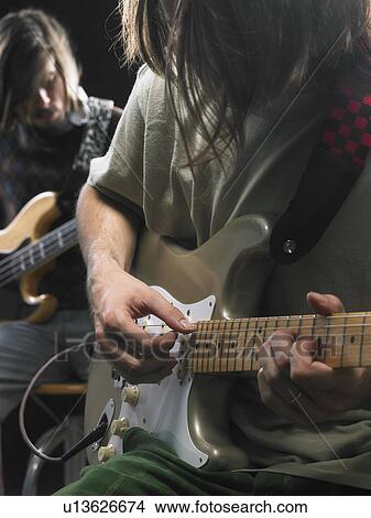 Two electric guitar players. View Large Photo Image Picture - Two electric guitar players.. Fotosearch