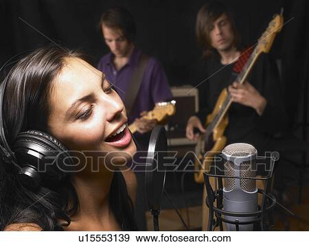 Stock Photo - Woman singing in a band.. Fotosearch