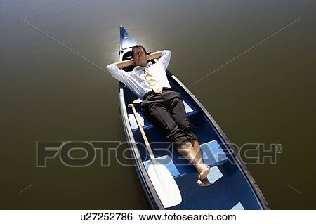 Businessman asleep in canoe. View Large Photo Image Stock Photograph - Businessman asleep in canoe.. Fotosearch