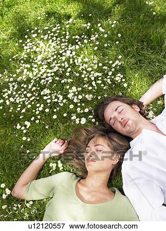 Couple sleeping in the grass. View Large Photo Image Stock Photo - Couple sleeping in the grass.. Fotosearch
