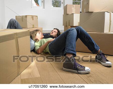 Couple sleeping on floor with moving boxes around them. View Large Photo Image Stock Image - Couple sleeping on floor with moving boxes around them.. Fotosearch