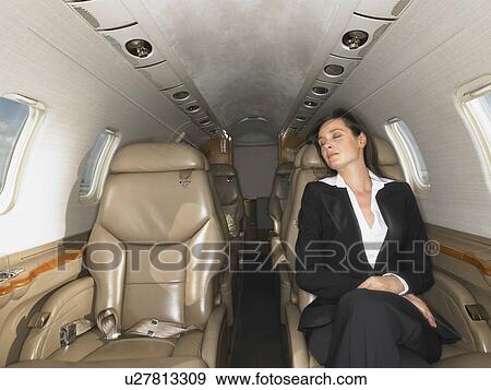 Sleeping woman on a private jet. View Large Photo Image Stock Photo - Sleeping woman on a private jet.. Fotosearch