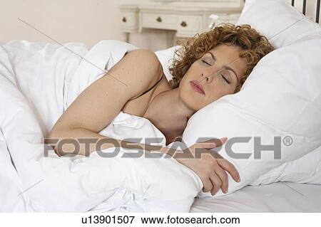 woman lying in bed eyes closed, close-up View Large Photo Image Stock Photo - woman lying in bed eyes closed, close-up. Fotosearch