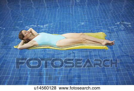 Woman lying on a lylo. View Large Photo Image Stock Photo - Woman lying on a lylo.. Fotosearch