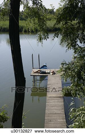 Woman lying on pier. View Large Photo Image Stock Photo - Woman lying on pier.. Fotosearch